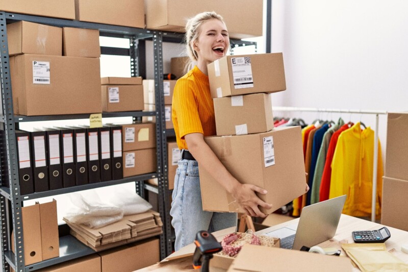 Smiling woman at online store warehouse. 